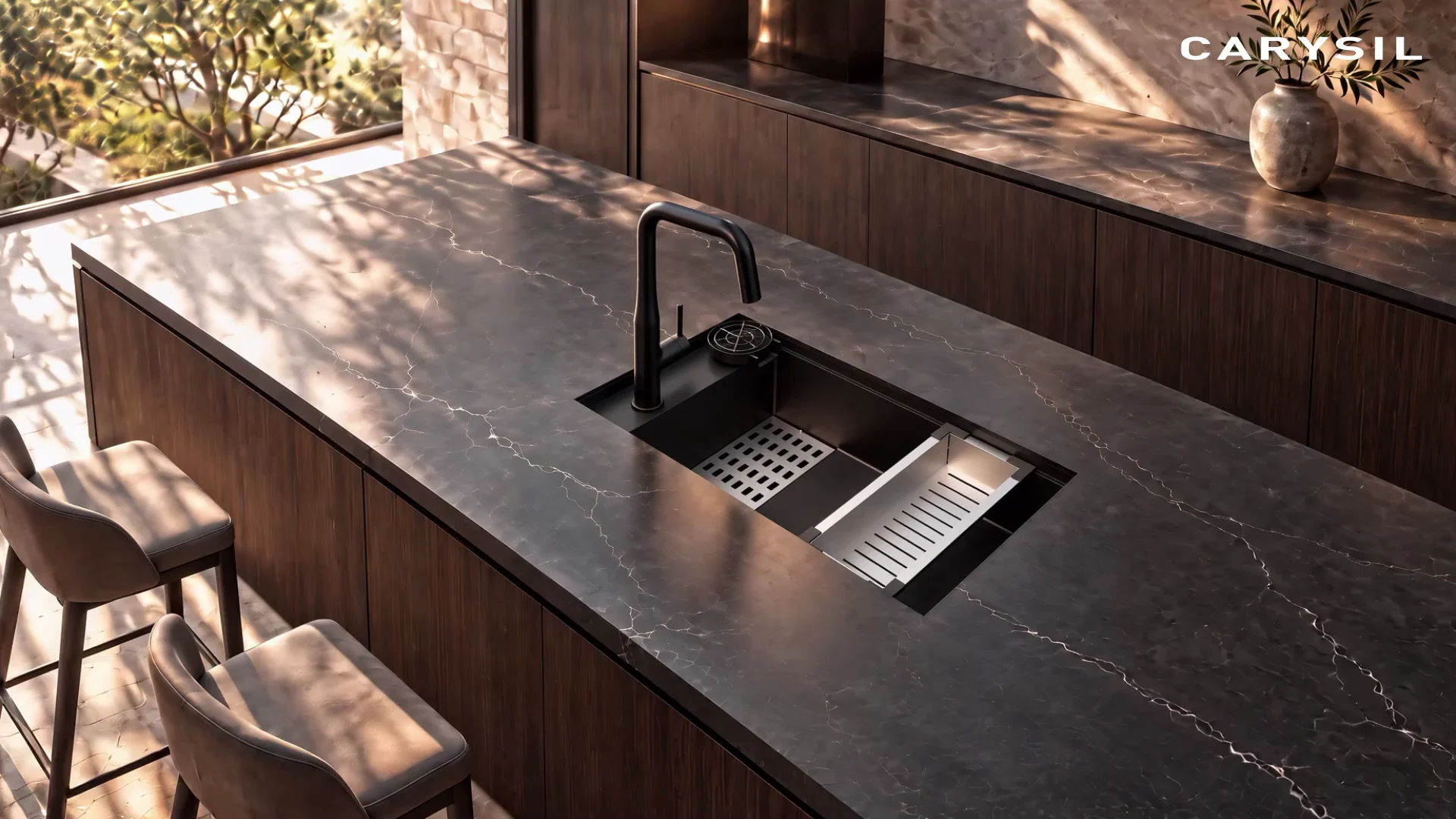 Carysil black granite sink with a black pull-out mixer on a dark stone kitchen island