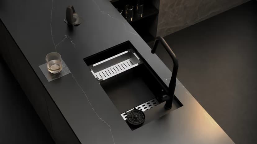 Carysil granite sink and mixer specified in a dark stone kitchen
